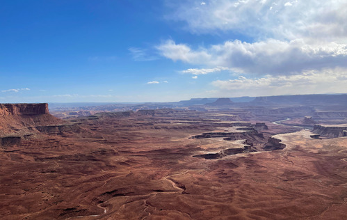 A river cuts through a maze of far off canyons.