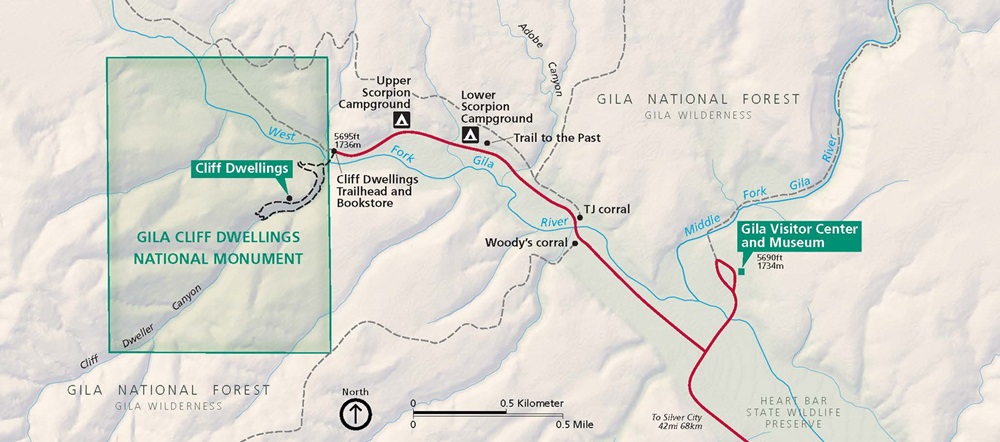 Map of Gila Cliff Dwellings National Monument in New Mexico. Two green, rectangular areas are outlined in darker green. Heart Bar State Wildlife Preserve is shown in pale mint green and connects them along West Fork Gilar River. Surrounding areas are beige, waterways are blue, and roads are red.