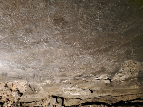 Signatures and drawings along the cave walls. 