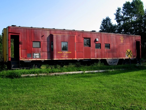 A caboose from the Bangor & Aroostook Railroad rests near the St. Francis Historical Society Museum.