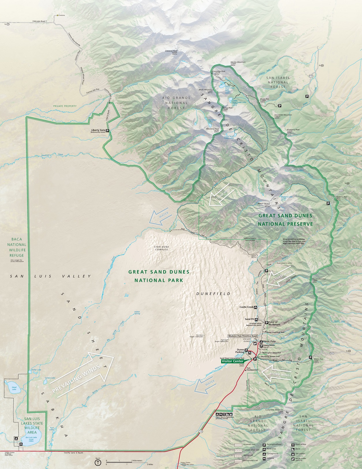 Map of Great Sand Dunes National Park and Preserve in Colorado. The Sangre de Cristo Mountains curve like a parenthesis up the right edge of the map to curl around the Dunefield south of center. The mountains are rendered in shades of green and the surrounding areas in beige.