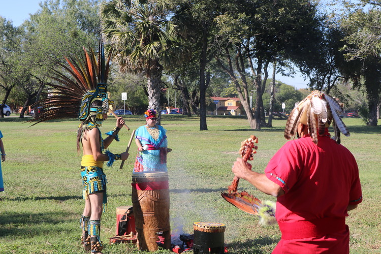 Two dancers circling around the drummer. 