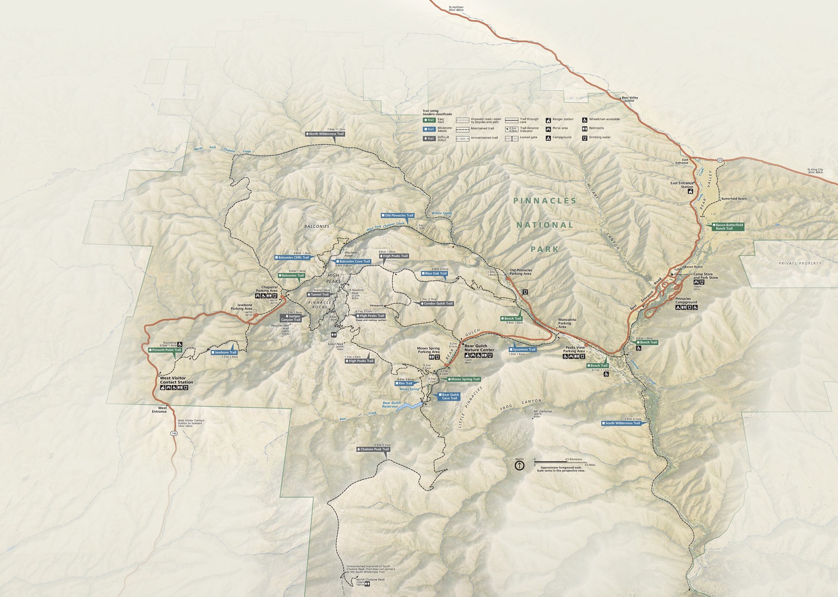 Oblique map of Pinnacles National Park in California. Terrain surrounding the roughly star-shaped park fades to a lighter brown outside the boundary. Two park roads, indicated in red, enter from the east and west but do not connect.