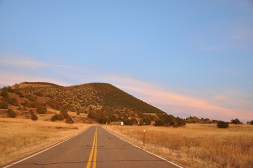 The entrance road to the Monument with Capulin Volcano in the background around sunset