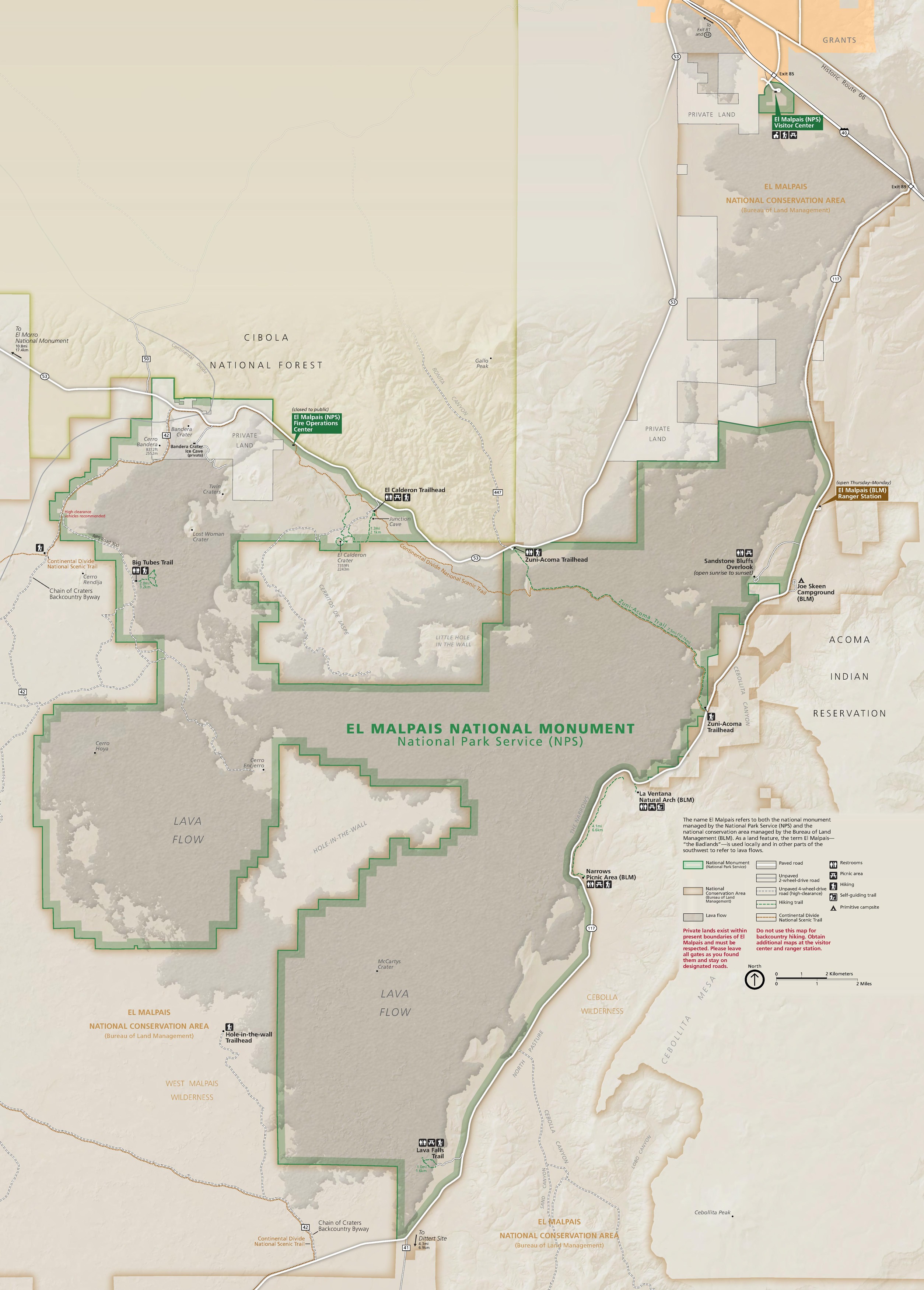 Park map of El Malpais National Monument in New Mexico. The park is outlined in green and filled in with shades of brown. The surrounding areas are beige.