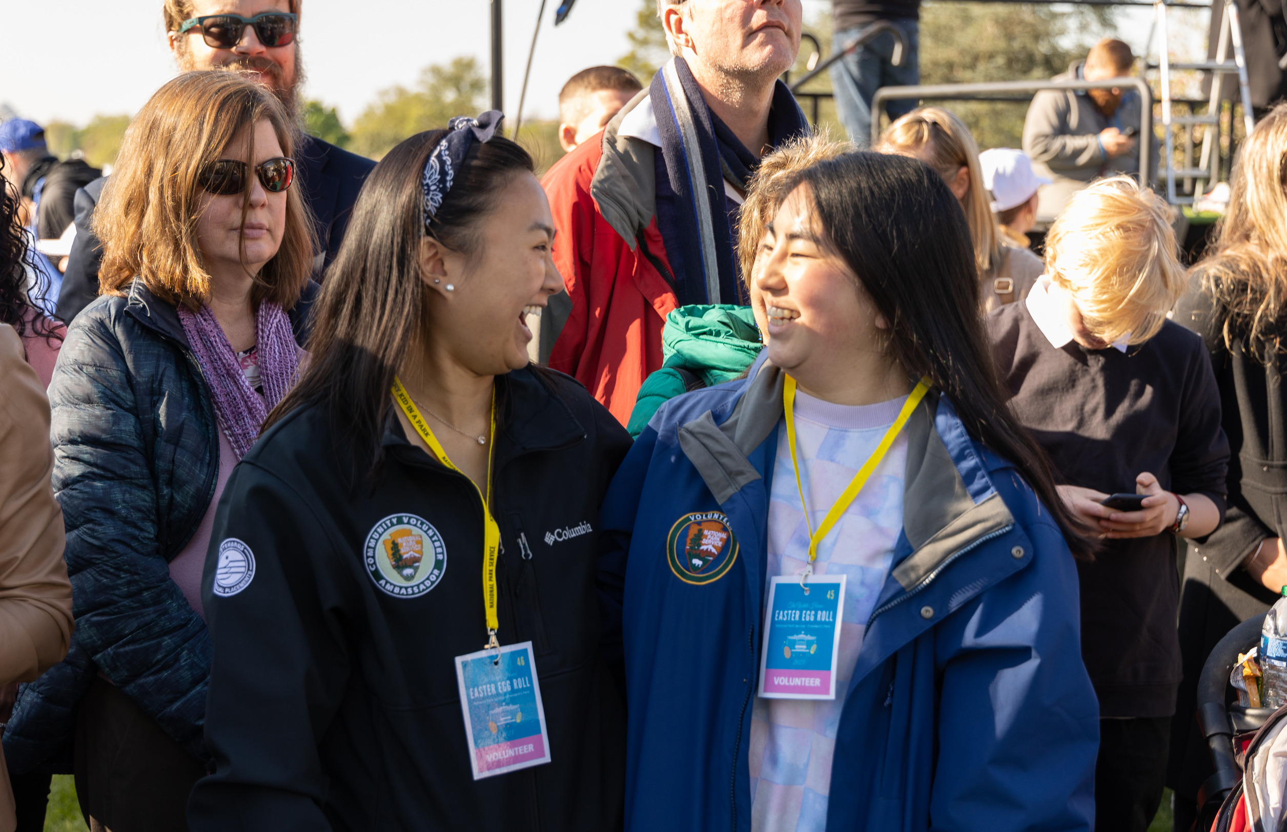 Two volunteers smile at each other