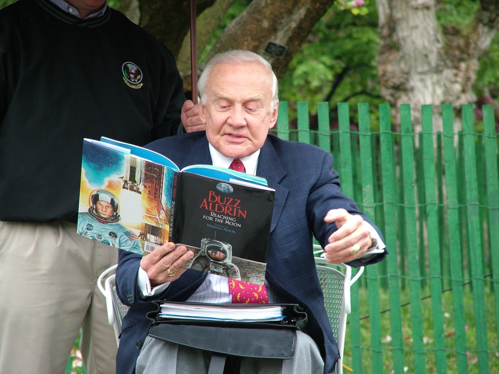 Astronaut Buzz Aldrin reads his book, "Reaching for the Moon," in the reading nook.