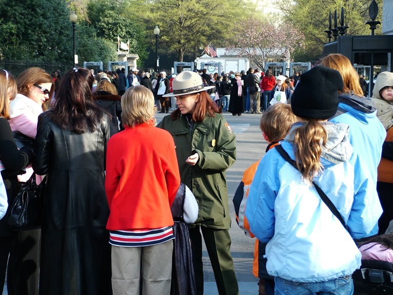 A Park Ranger greets ticket holders in line