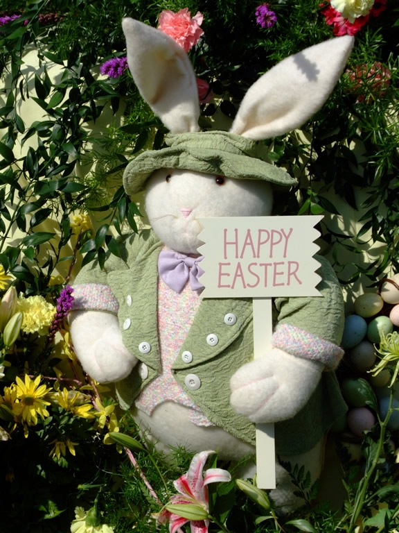 A bunny prop holds a sign that read "Happy Easter" 