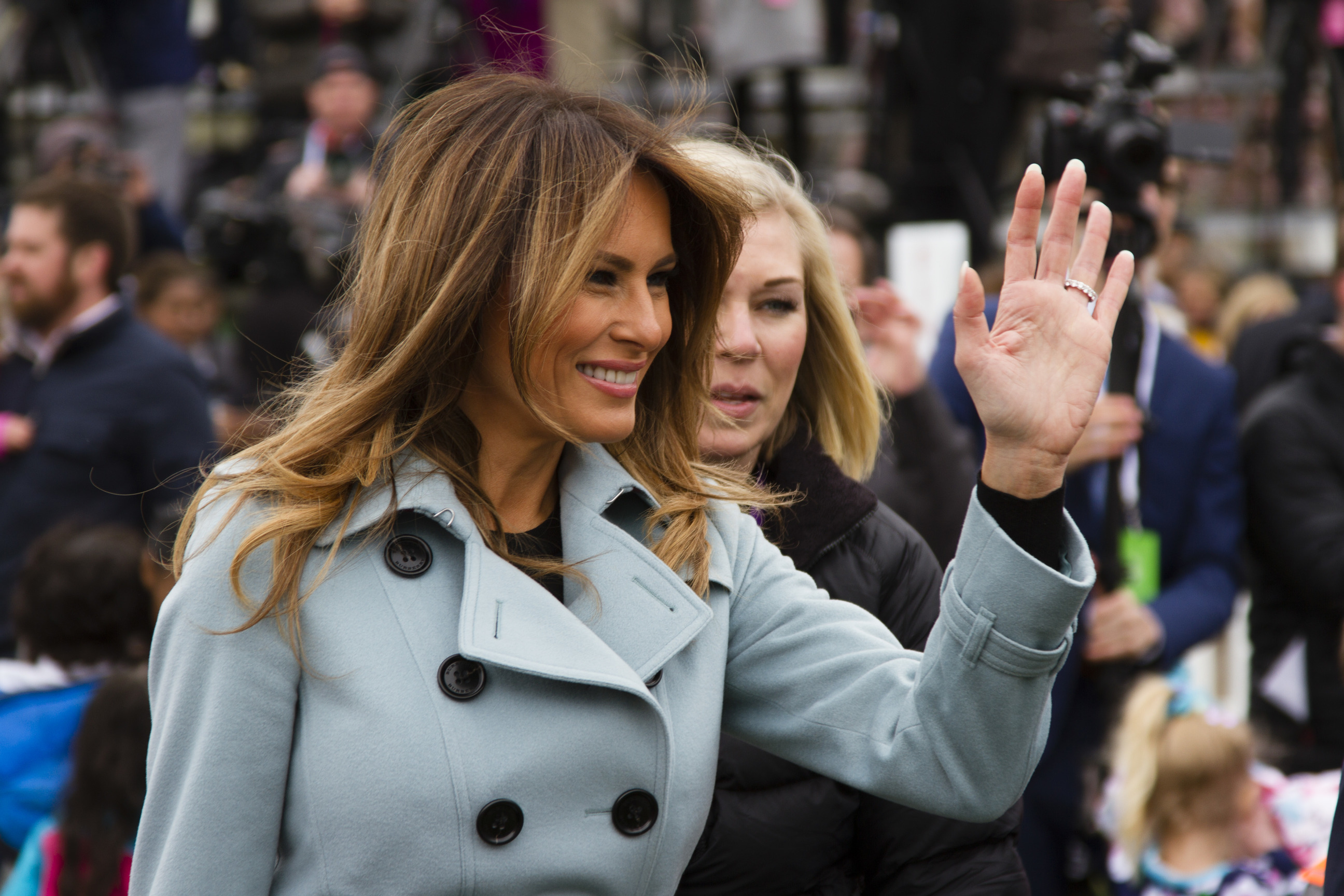 First Lady Melania Trump waves to a crowd of visitors. 