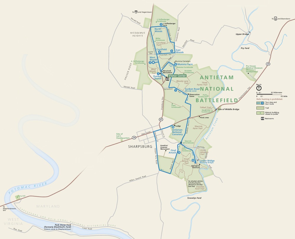 Map of Antietam National Battlefield in Maryland. The park, shown in green, is shaped like a blocky, elongated and bent oval, sitting northeast of the winding Potomac River. A tour route spans the park from top to bottom, and Antietam Creek snakes through much of the park.