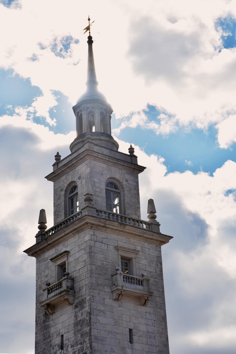 Belfry level with windows with a spire on top of the monument.