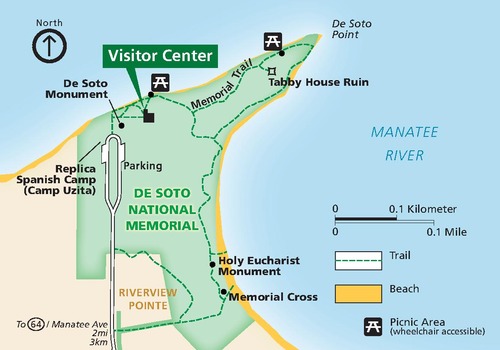 Map of De Soto National Memorial, which covers most of a peninsula surrounded by the Manatee River in Florida. The water is blue around the park, which is shown in green. Trails, picnic areas, and several sites are labeled. 