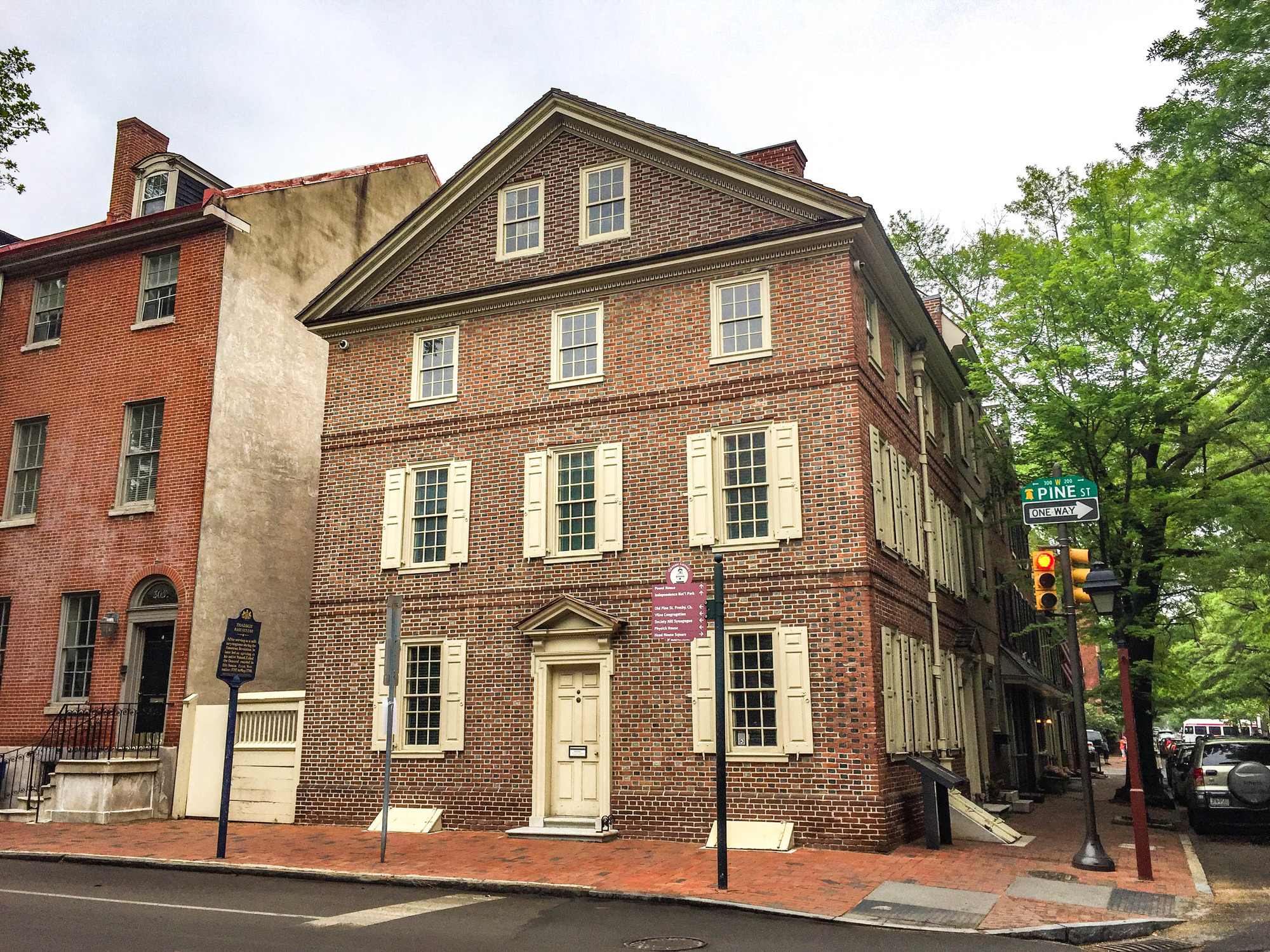 Four-story brick house on a street corner