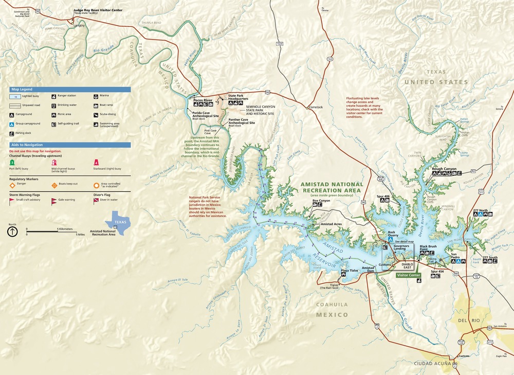 Map of Amistad National Recreation Area in Texas. The park area is shown as a long, thin green strip of land that snakes along the US-Mexico border, from the Rio Grande to the Amistad Reservoir and the Devils River. US land is shown in white, and Mexico is represented in beige.