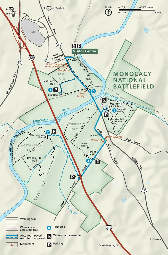 Map of Monocacy National Battlefield in Maryland. The park takes up most of the map and is highlighted in dark green with the surrounding area in light green. Roads are represented by black, blue, and red lines. Trails are represented by dashed lines.