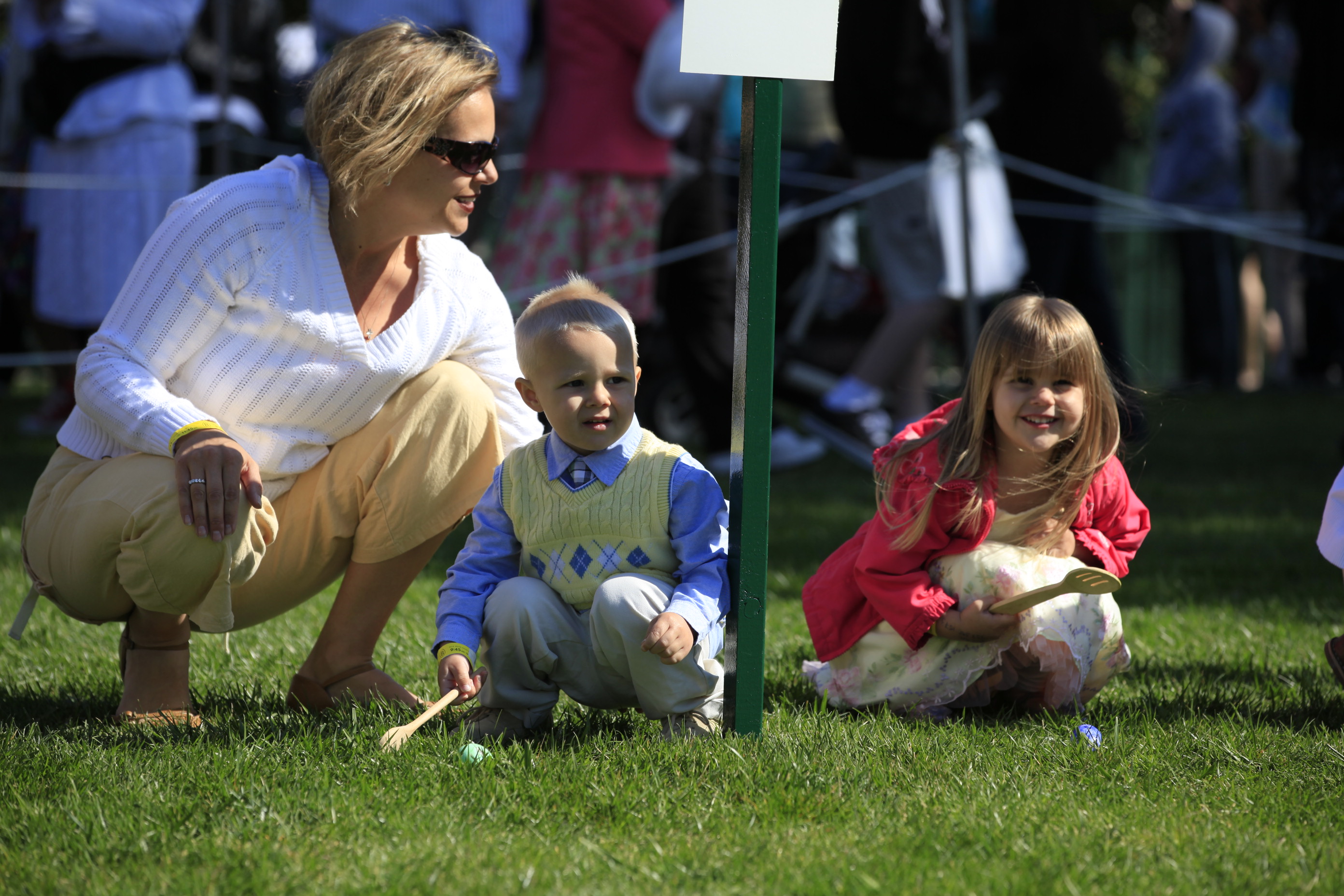 Two young children wait for the Egg Roll to start.