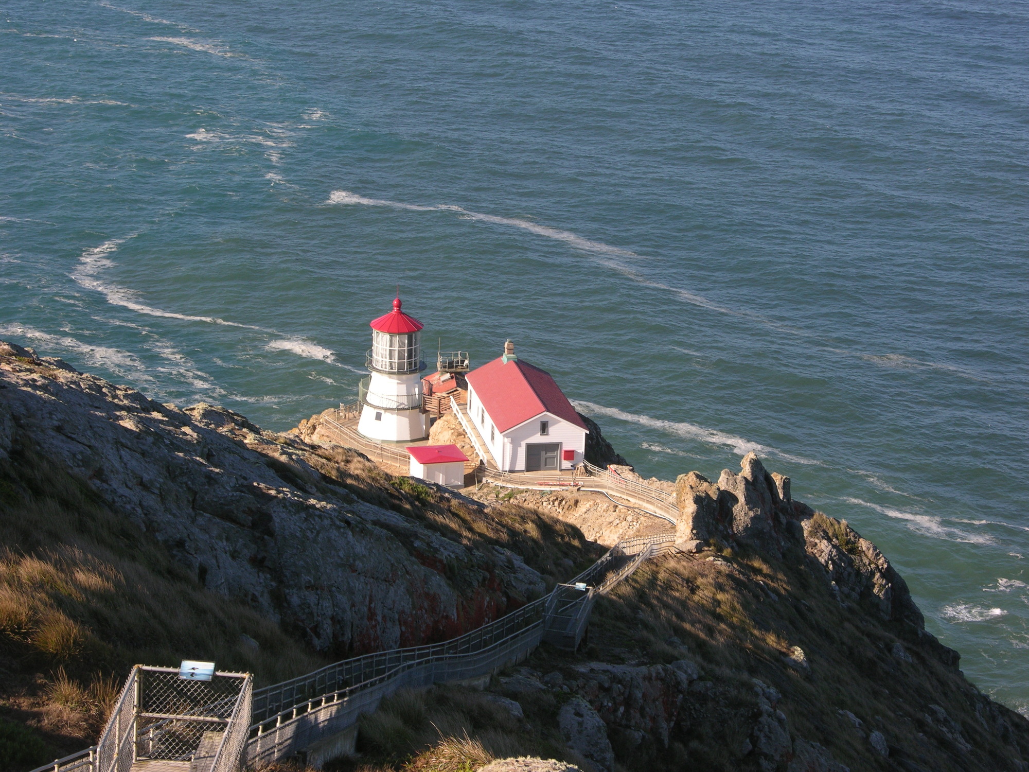 Family Campgrounds California Four white-sided, red-roofed structures sit on a rocky headland above the Pacific Ocean.