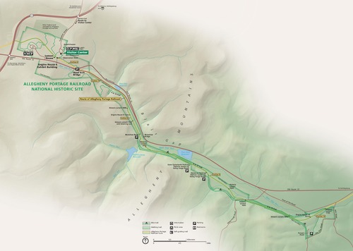 Map of Allegheny Portage Railroad National Historic Site in Pennsylvania. The long, narrow site stretches from the upper left corner of the map to the lower right corner through the Allegheny Mountains and is highlighted in green. The terrain around it is shaded in tan.