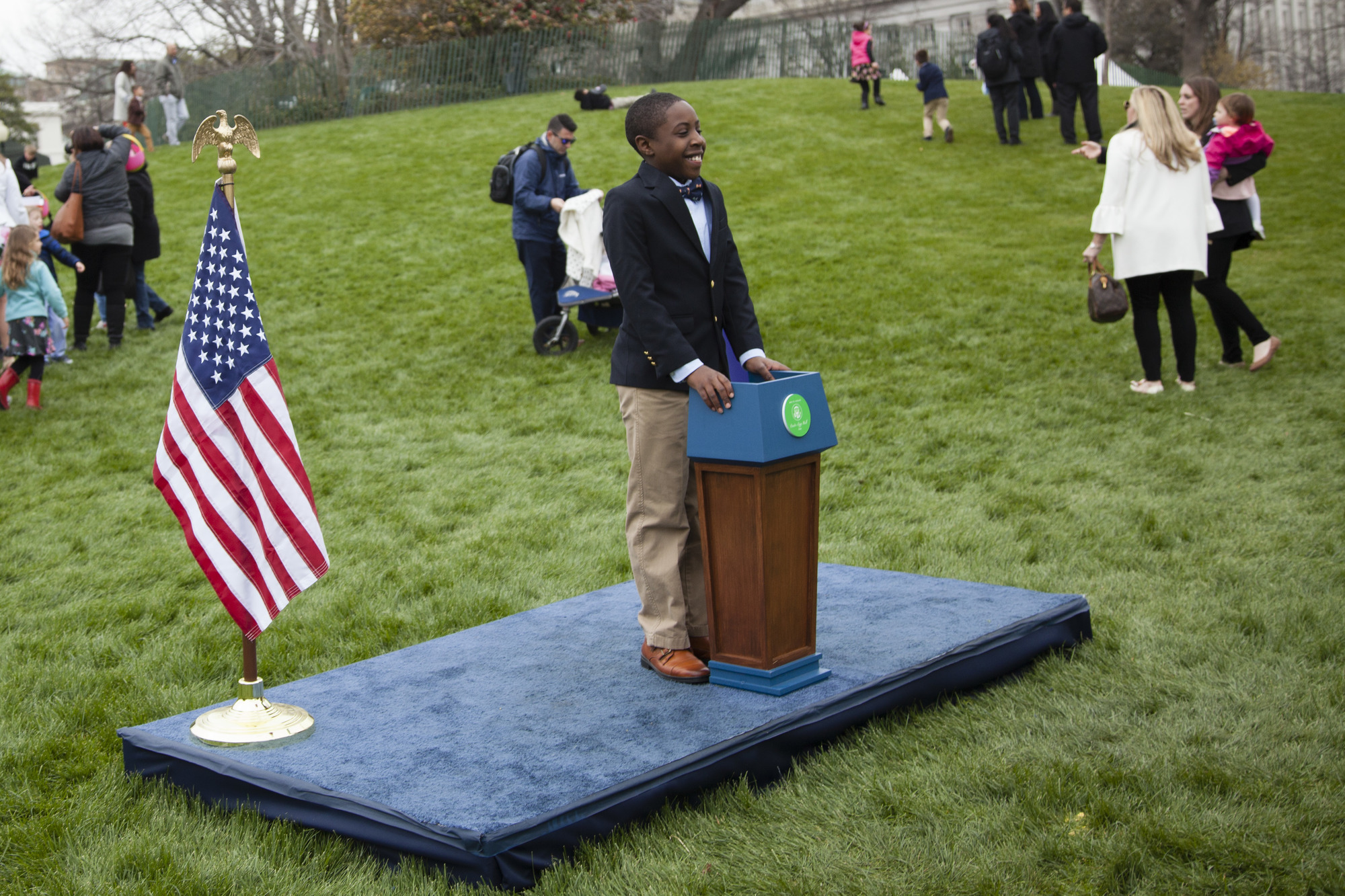 A young boy poses as the future President of the United States in front of the White House. 