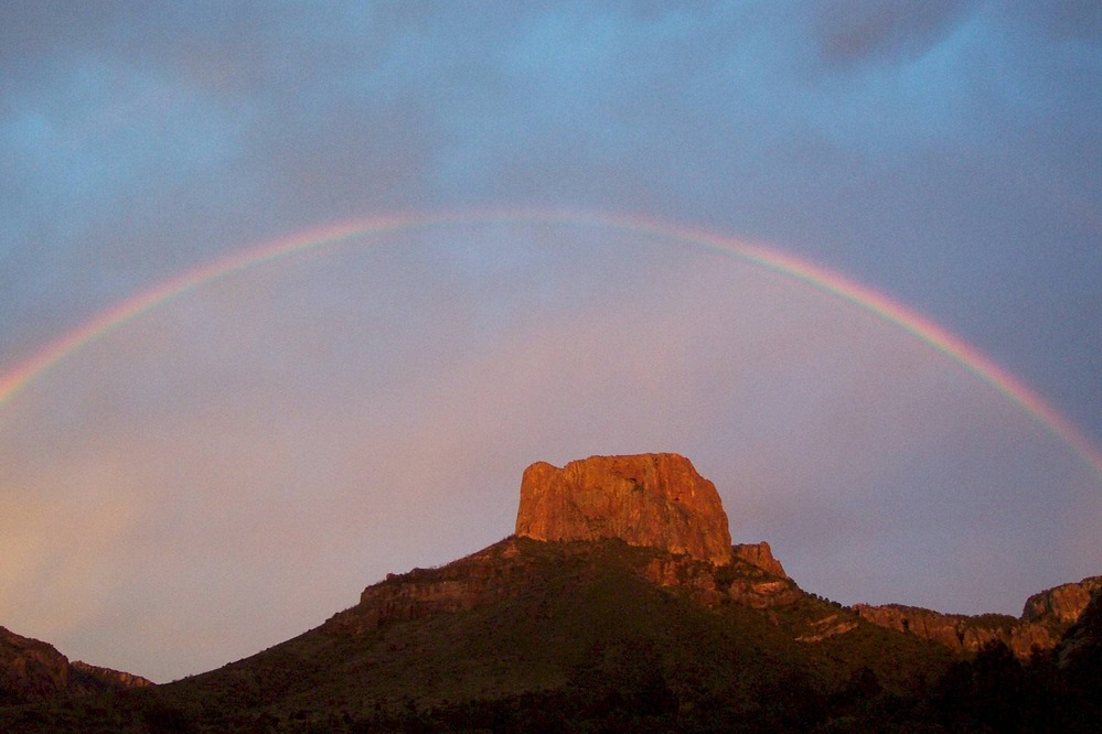 Rainbow over the bright orange cliffs of Casa Grande.