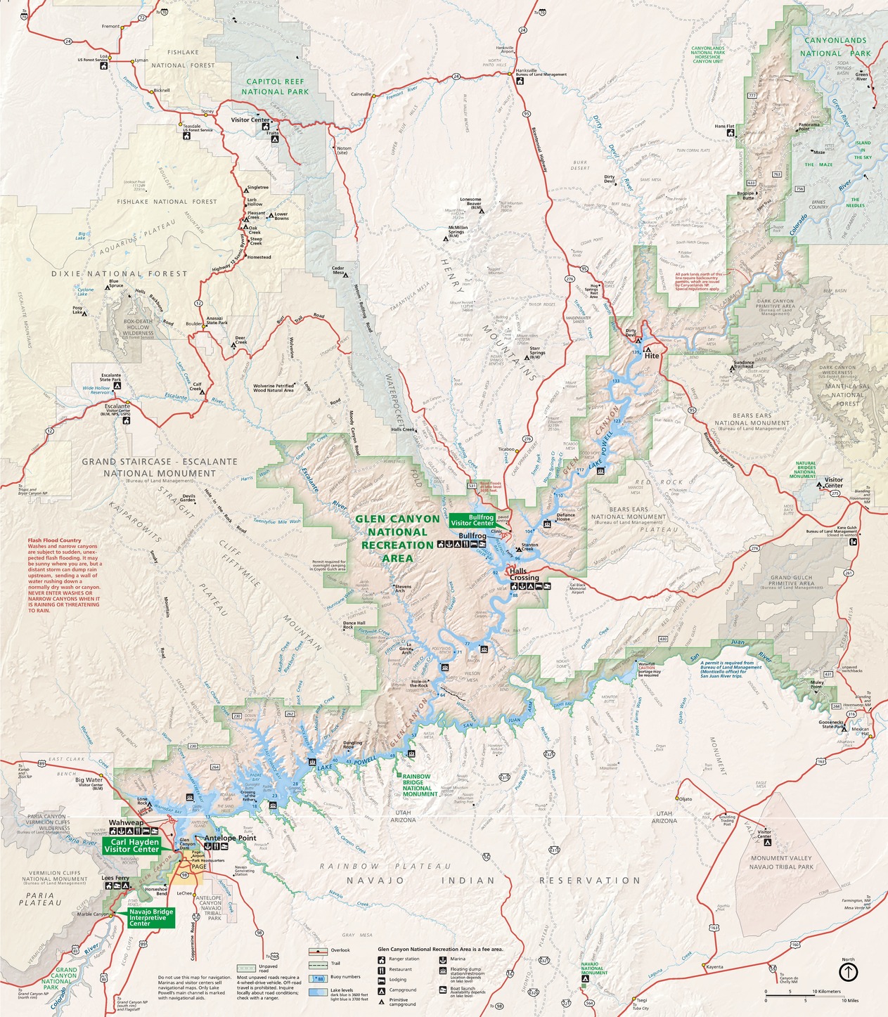 Park map of the Glen Canyon National Recreation Area in Arizona. The park runs diagonally across the map in a narrow strip and is highlighted in tan with green shading around the edges. The surrounding area is a light shade of tan with roads represented by red lines.