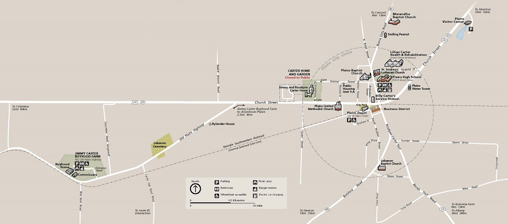 Map of Jimmy Carter National Historical Park in Georgia. The tan-colored map has white streets and three-dimensional depictions of buildings and sites, capturing the entire town of Plains and the Jimmy Carter Boyhood Farm outside the city limits.