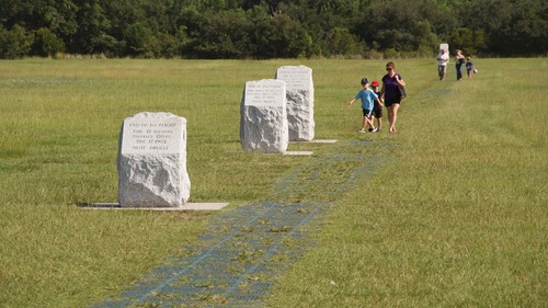 Visitors walking down the Wright brothers' flight path