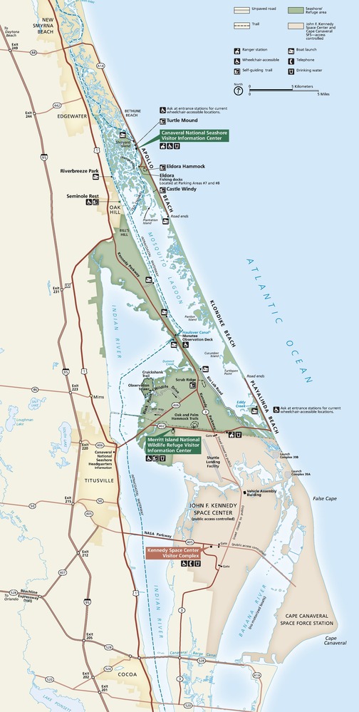 Map of Canaveral National Seashore and Merritt Island National Wildlife Refuge in Florida. The seashore and refuge are shown as a green area, the John F. Kennedy Space Center just south of it is tan, towns on the coastline are muted yellow, roads are represented in red, and the rest of the area is eggshell white.