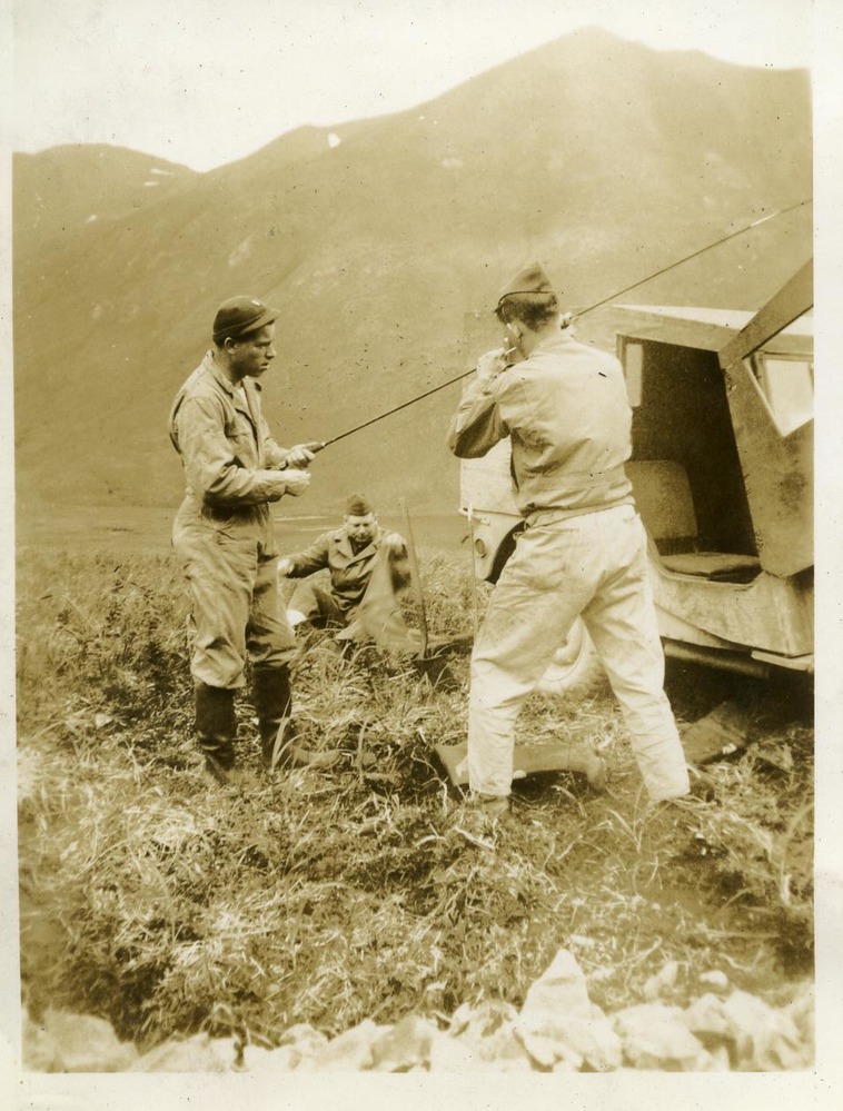 Two men outside with fishing gear