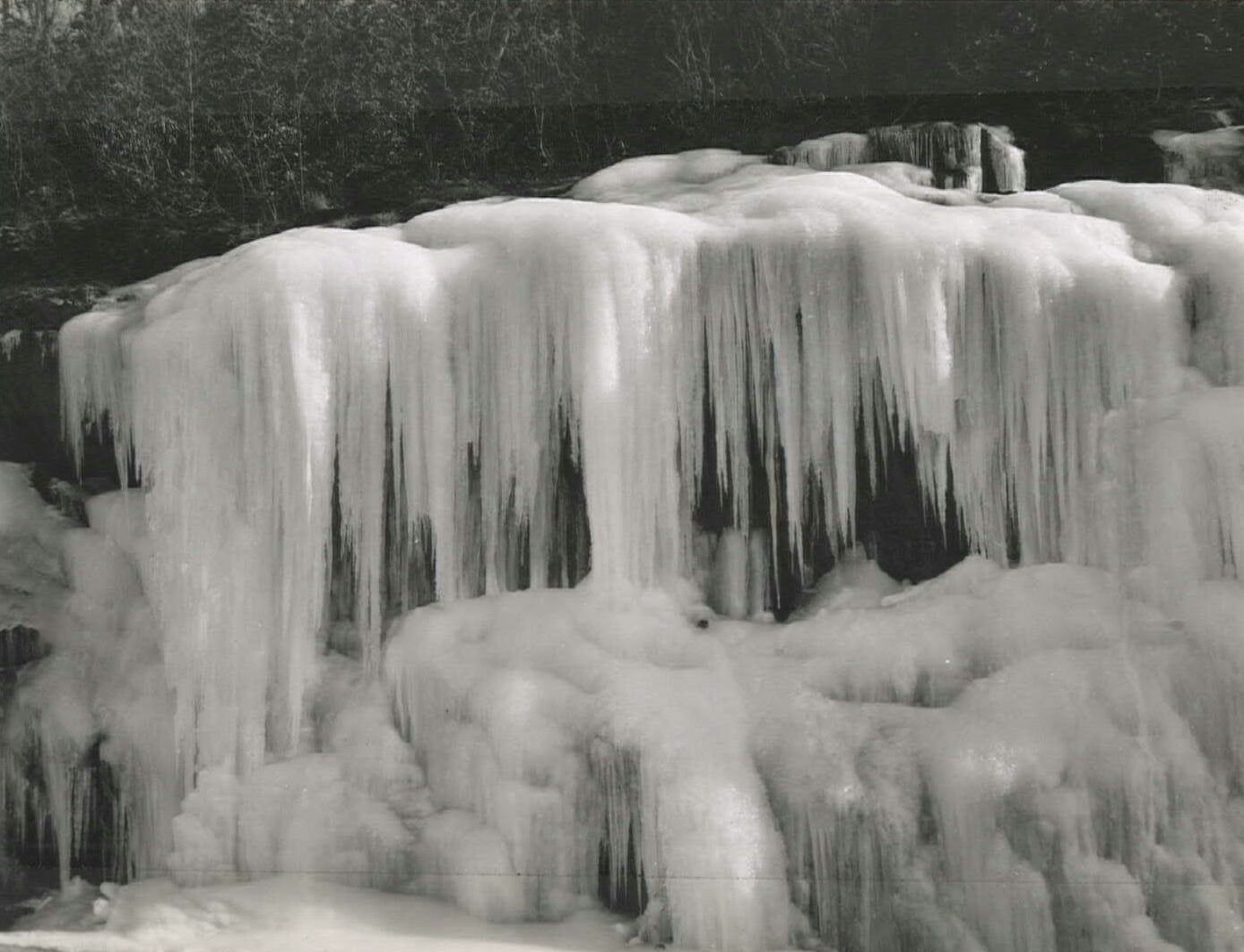Icicles on rocks along a road