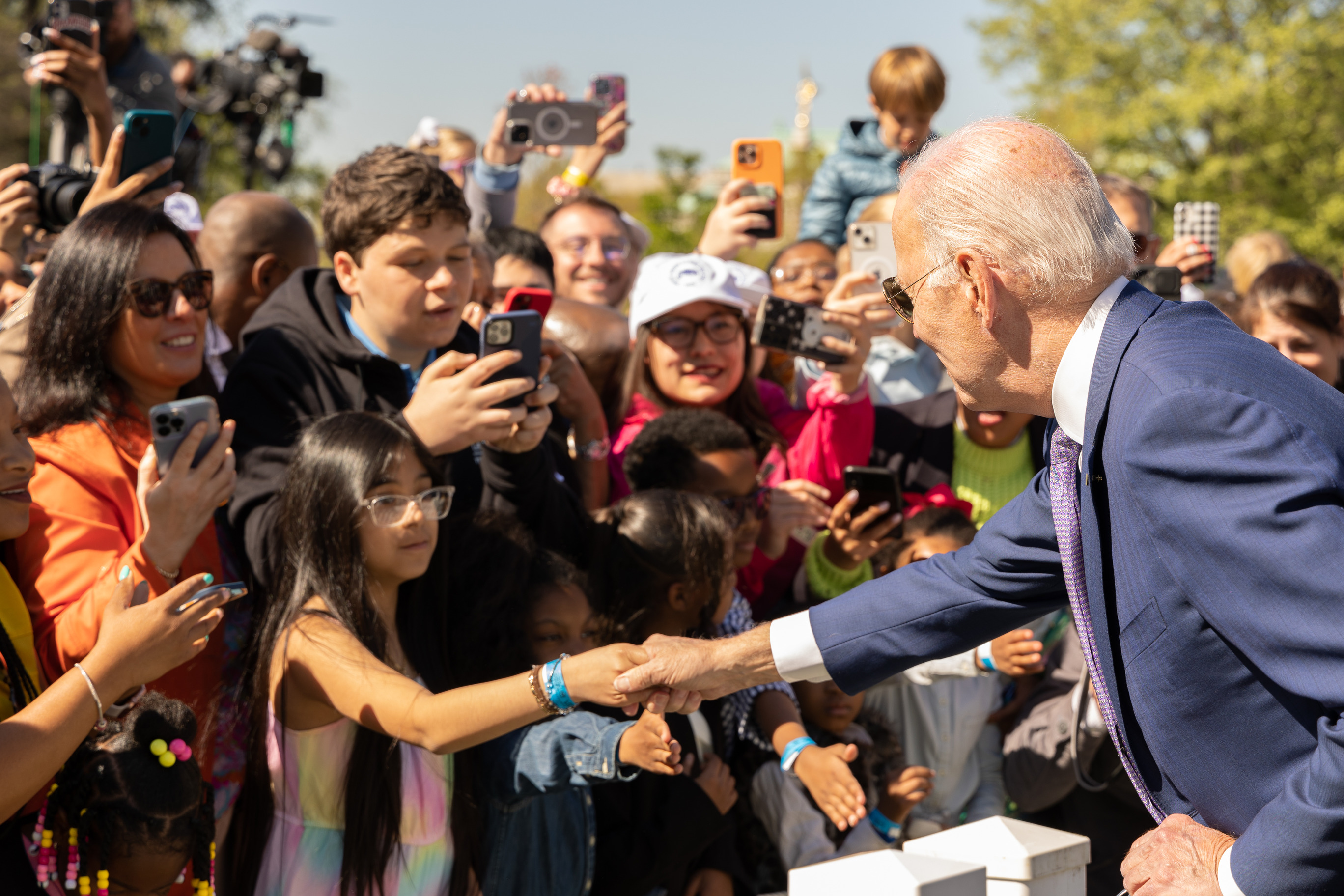 President Joe Biden shakes hands at the 2023 White House Easter Egg Roll