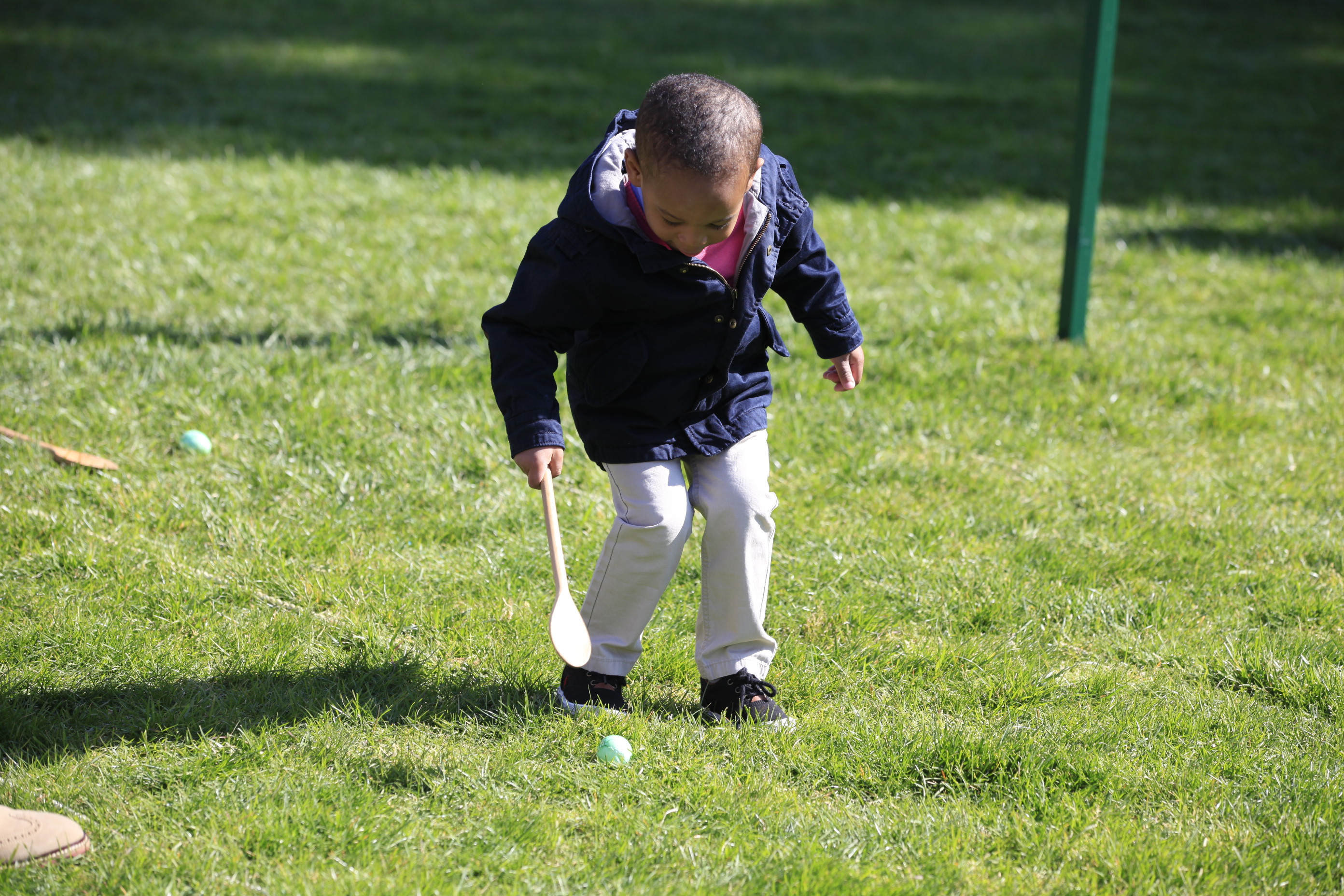 A young child participates in the Egg Roll. 