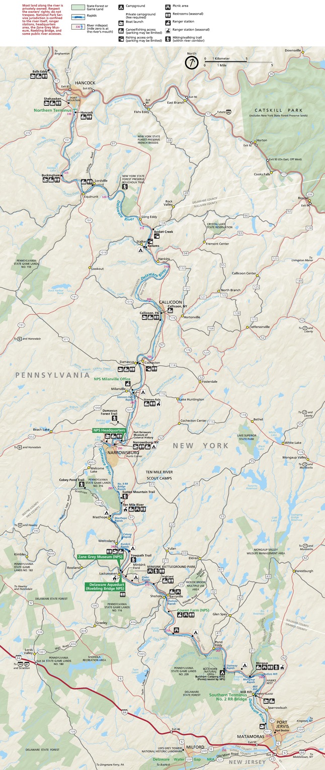 Map of the Upper Delaware Scenic and Recreational River, beginning near Hancock, New York, and ending near Port Jervis, New York. Campgrounds, Picnic Areas, Trails, Fishing Areas, and other features sit close to the river, and more than a dozen state forests and game lands, shown in green, are strewn about the long and narrow map.