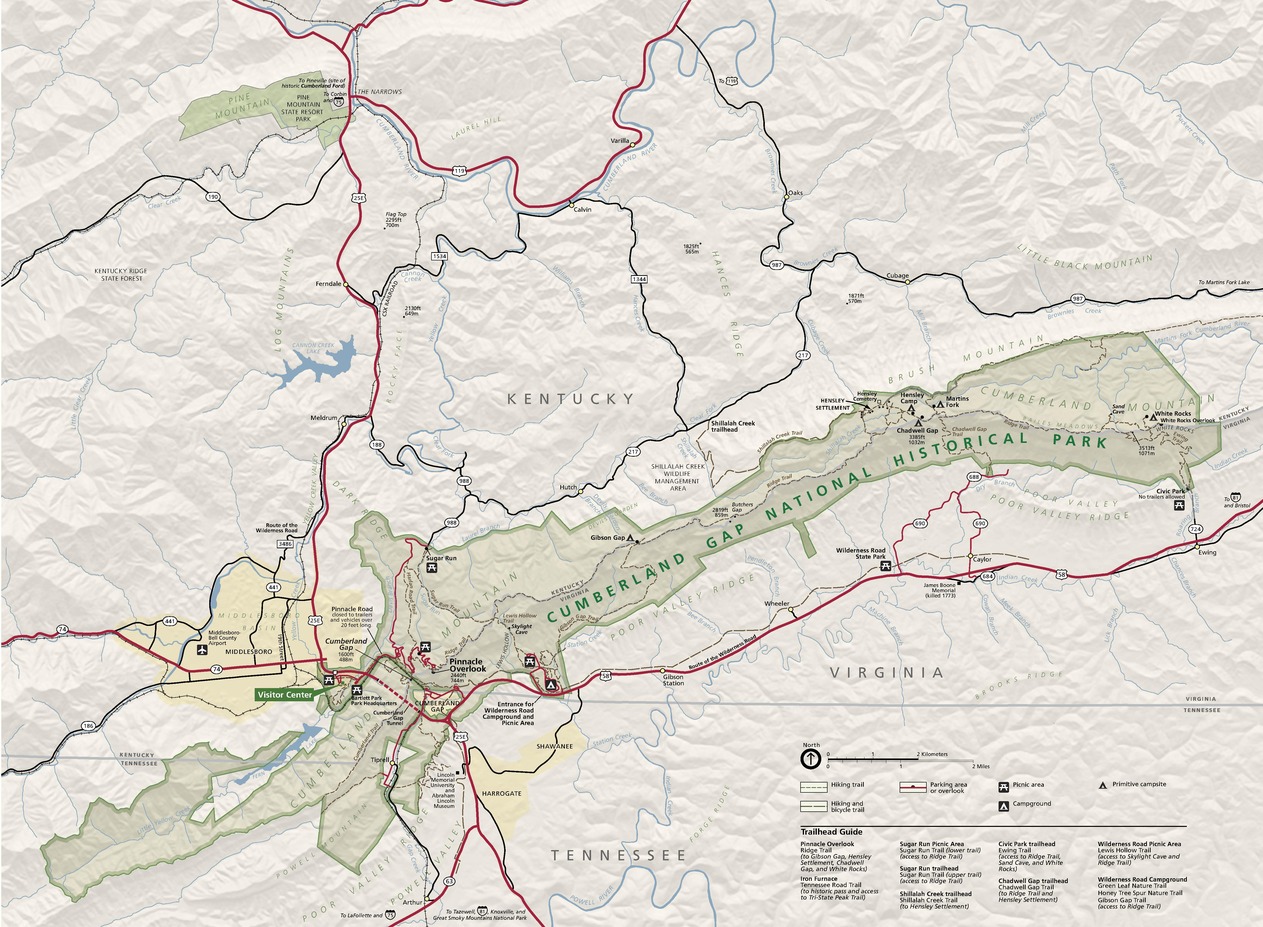 Map of the Cumberland Gap National Historical Park that encompasses portions of Kentucky, Tennessee, and Virginia. The park is shown in muted green, the surrounding terrain in shimmering tan, and roads as red or black lines.