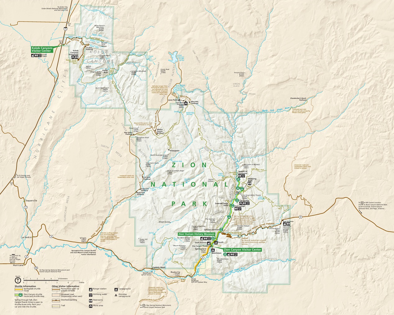 Map of Zion National Park in Utah. The park is made up of two roughly square sections connected at the northwest corner. Boundaries are shaded green, and terrain in the park is white. Surrounding areas are tan.