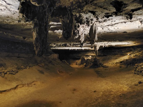 Stalactites hanging from the ceiling of the cave. 