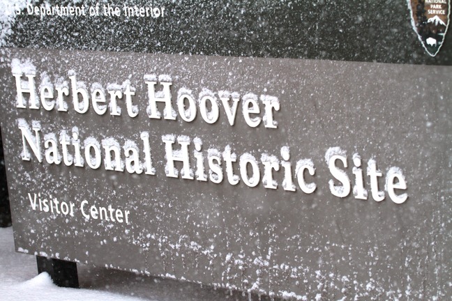 Snow collects on the raised letters of a sign for Herbert Hoover National Historic Site.