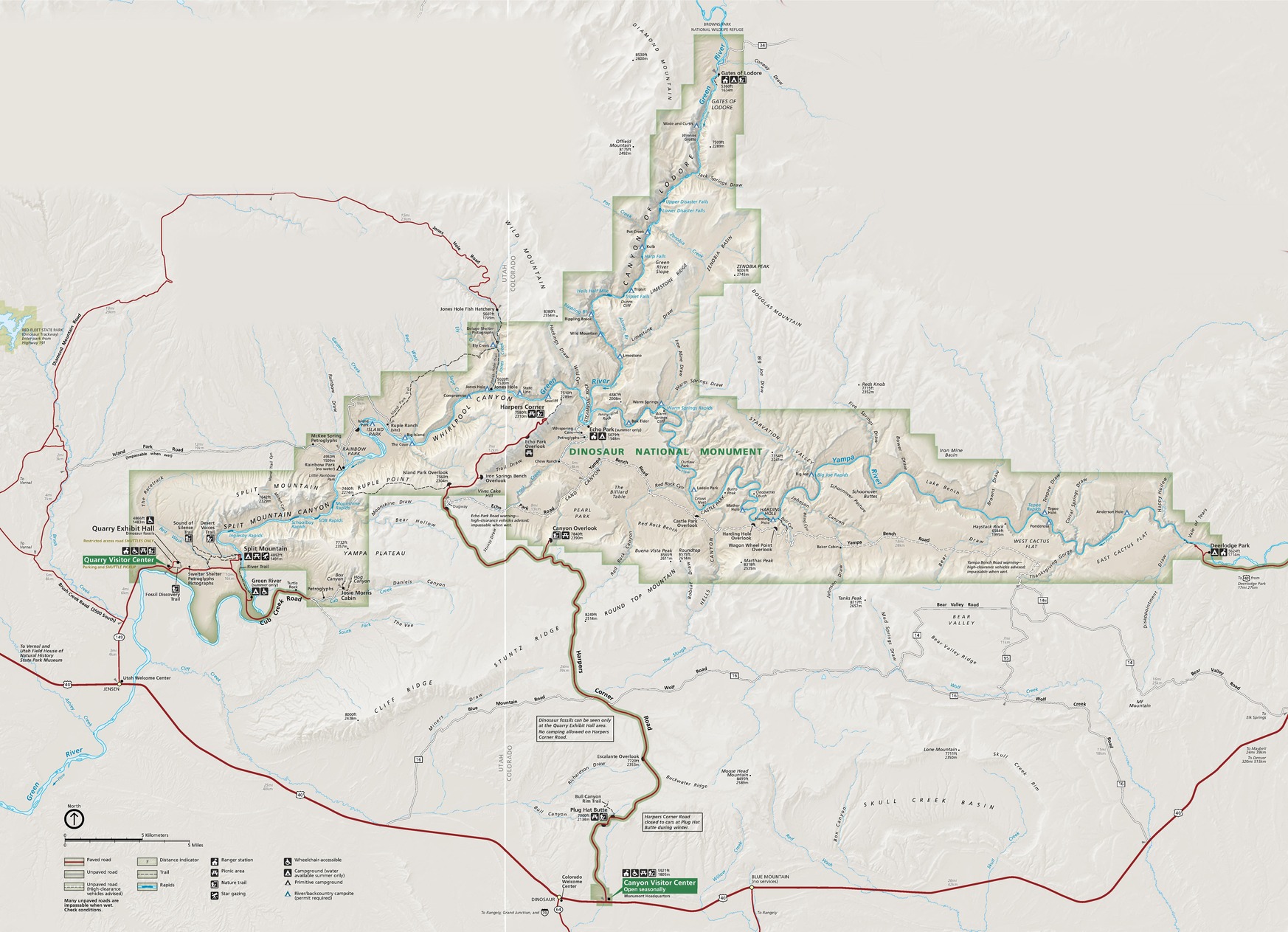 Map of Dinosaur National Monument in Colorado. Shown in green, the park has stepped, boxy boundaries that extend to the left, up, and right in three distinct arms. Most of the park is in Colorado but the western arm reaches into Utah. Most of the surrounding areas are tan and the roads are shown in red.