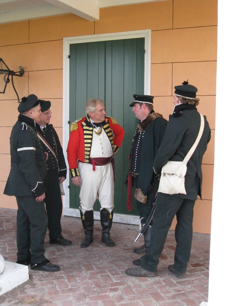 British troops discuss the invasion's progress on the porch at headquarters