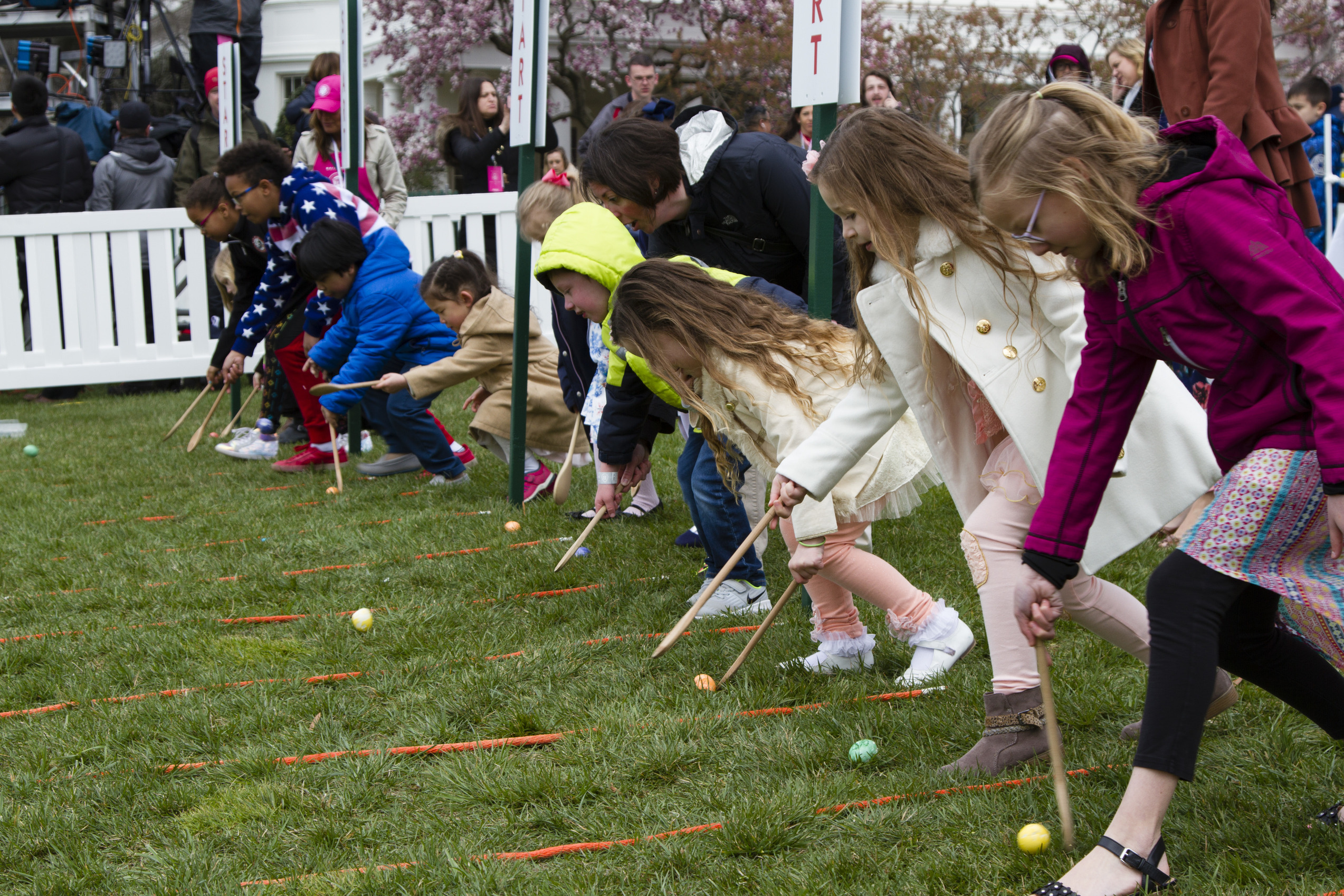 Several children participate in the Egg Roll. 