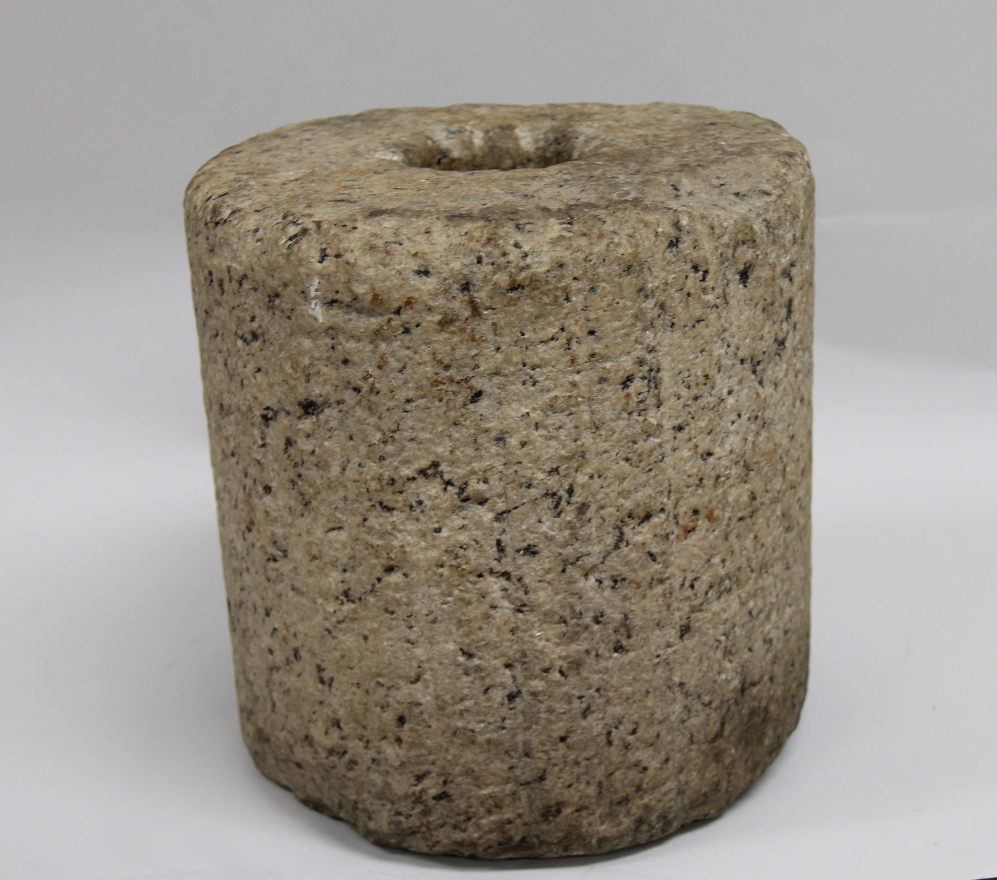 A cylindrical stone with a circular hole down the center