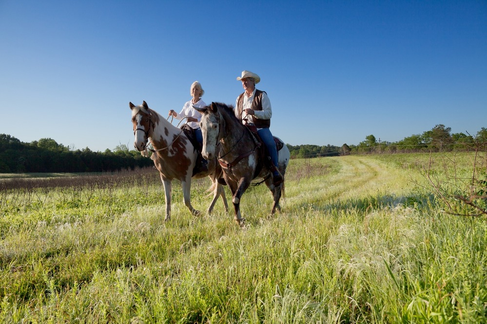 Two horseback riders enjoy an early morning ride along the Natchez National Scenic Trail, near Chickasaw Village (milepost 261.8).