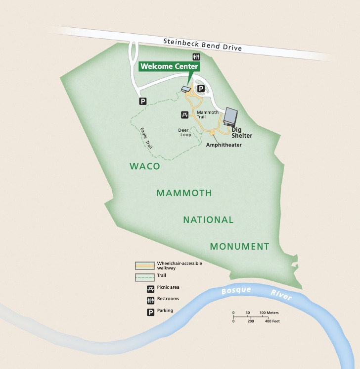Map of Waco Mammoth National Monument in Texas. The park, shown in green, stretches between Steinbeck Bend Drive in the north and the Bosque River in the south. A Welcome Center, Dig Shelter, and trails are clustered in the northeast. 