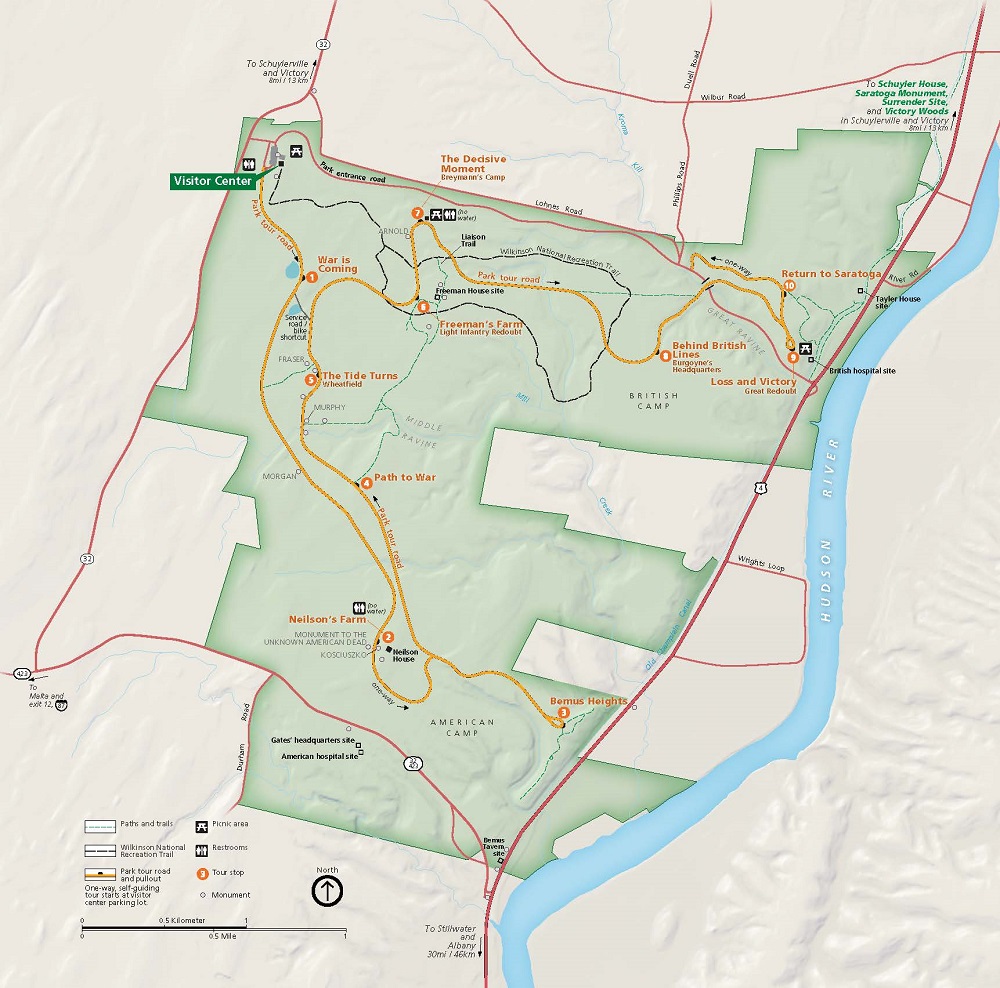 Map of Saratoga National Historical Park in New York. The park area, shown in green, is shaped like a blocky letter E. West of the Hudson, the park touches the riverbank at two points. The map shows roads around and through the park, including the self-guiding park tour, as well as paths and trails.