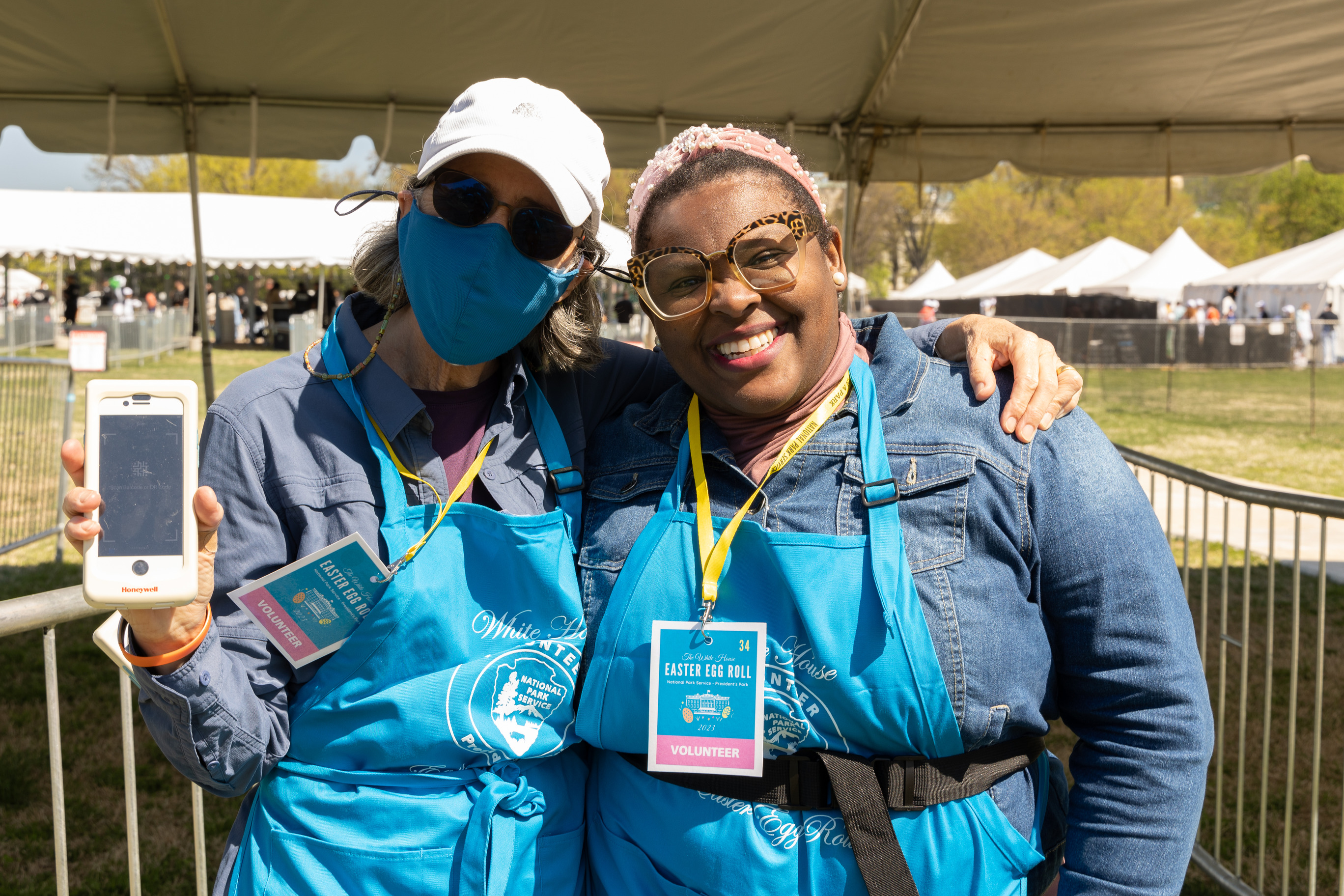 Two volunteers pose and smile at the camera