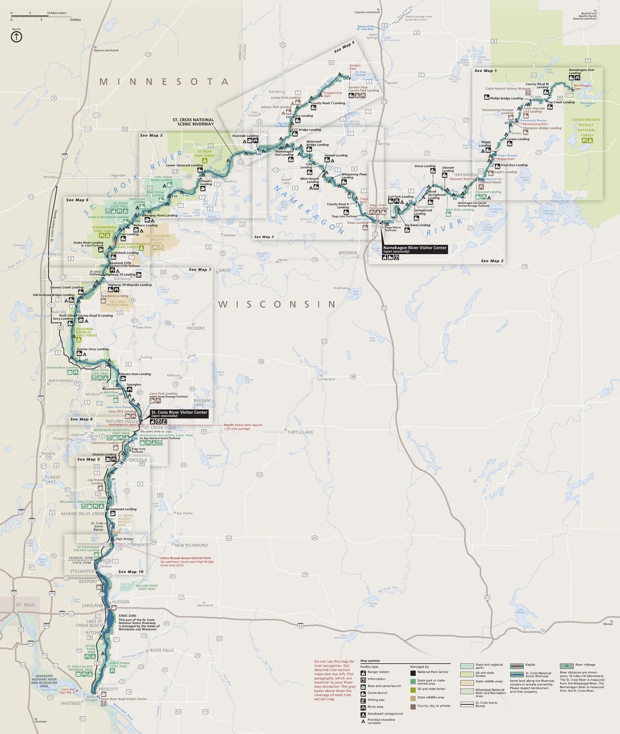 Map of Saint Croix National Scenic Riverway on the border of Minnesota, colored beige, and Wisconsin, colored off-white. The park, colored green, is a winding line that runs north, following the St Croix River and state border, then cuts east across Wisconsin. Ten boxes that appear to magnify sections of the riverway are spread like playing cards down the map.