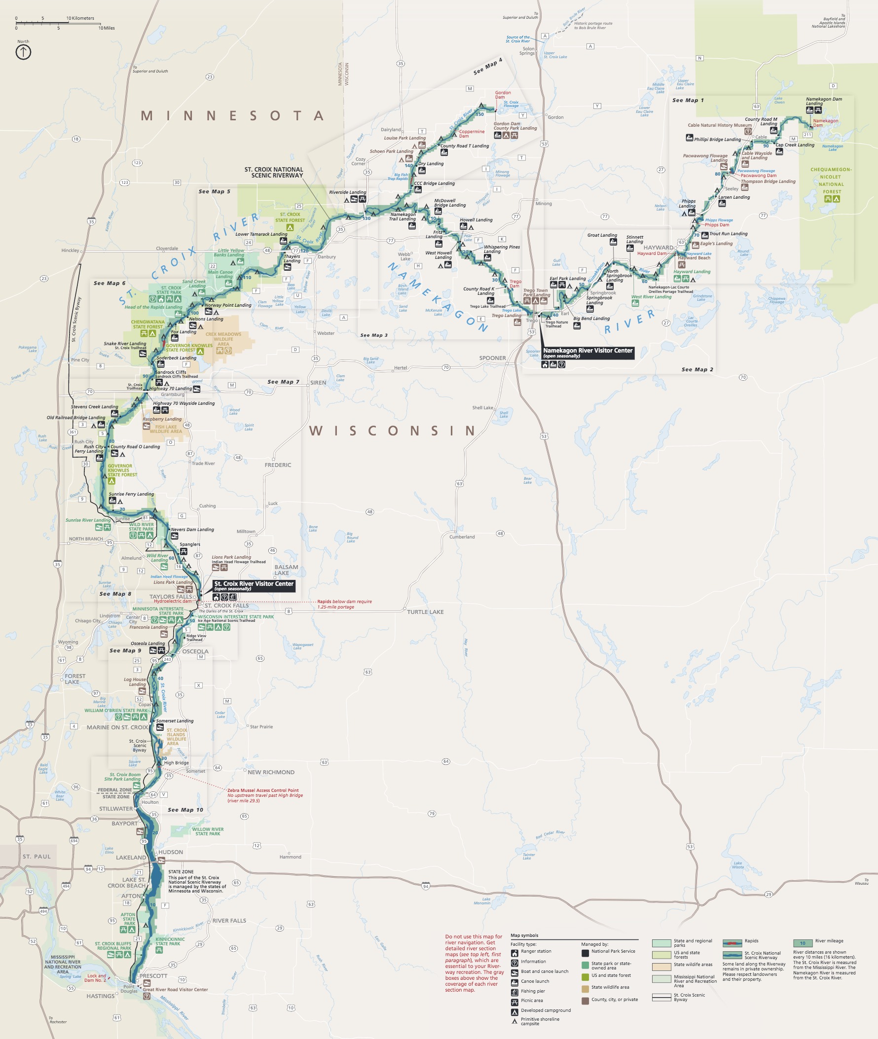 Map of Saint Croix National Scenic Riverway on the border of Minnesota, colored beige, and Wisconsin, colored off-white. The park, colored green, is a winding line that runs north, following the St Croix River and state border, then cuts east across Wisconsin. Ten boxes that appear to magnify sections of the riverway are spread like playing cards down the map.
