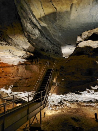 A metal staircase connecting two cave passages. 