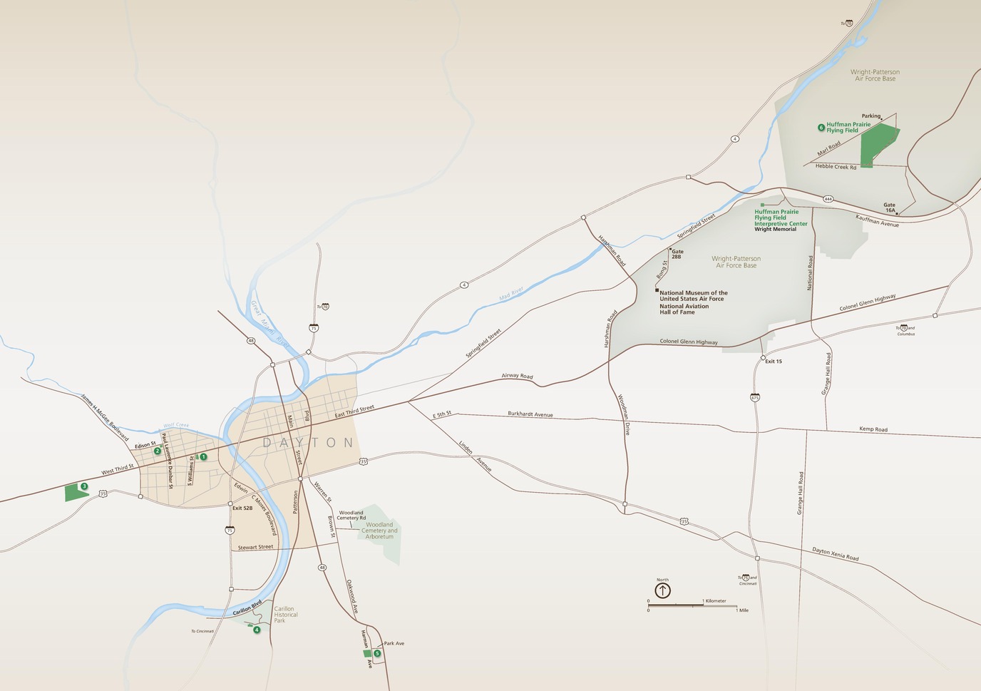 Map of Dayton Aviation Heritage National Historical Park in Ohio. Park sites are shown in green in and around Dayton, which is shaded tan. The blue Great Miami River winds down Dayton, and the Mad River trails out northeast. Roads represented by brown lines spray outward east of Dayton.